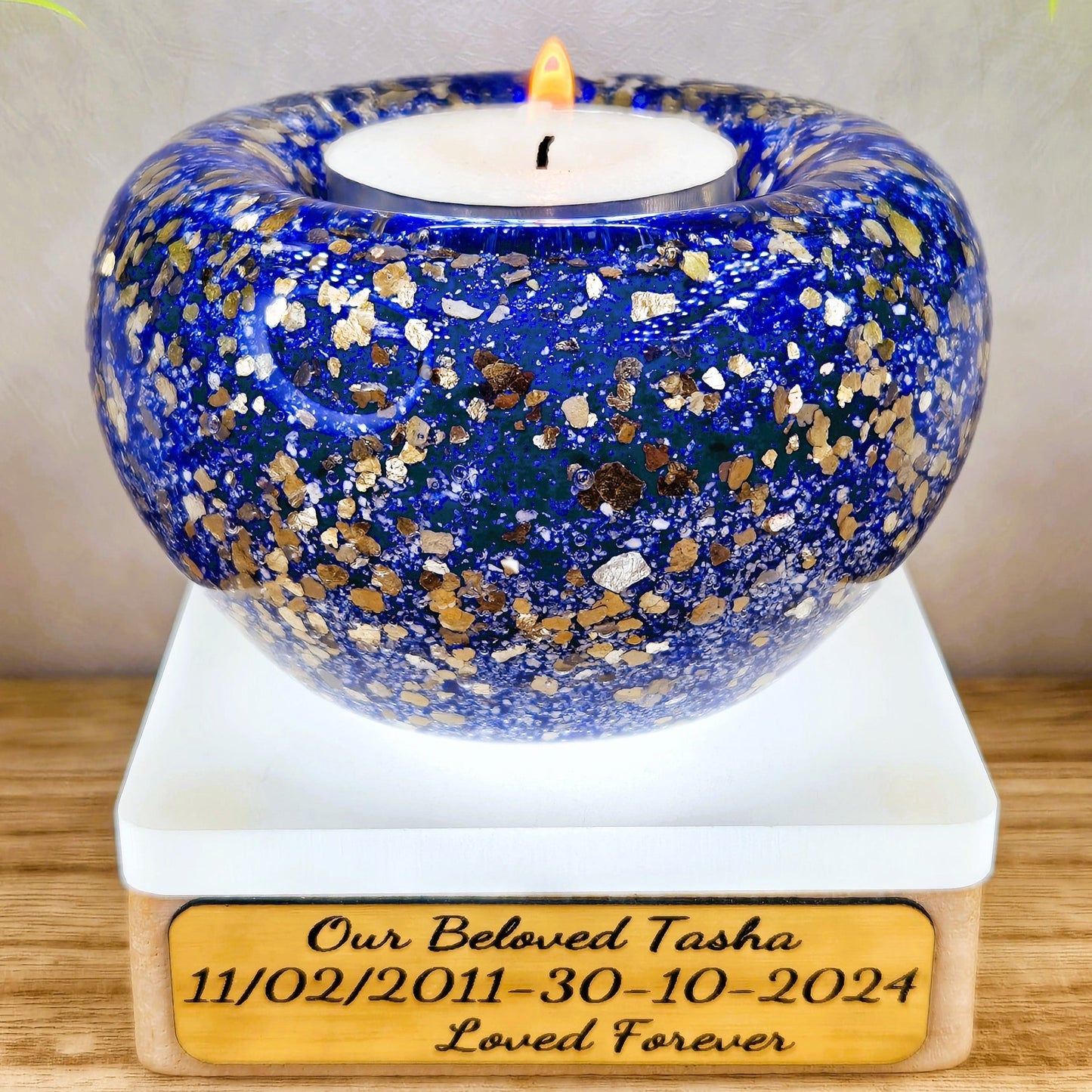 Ashes in glass tealight silver & gold flakes.